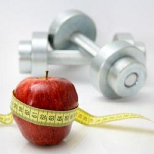 Apple sitting next to small weights