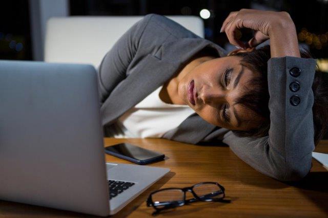 Woman falling at asleep at desk